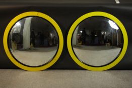 A pair of vintage yellow framed convex circular mirrors. Dia.70cm. (each)