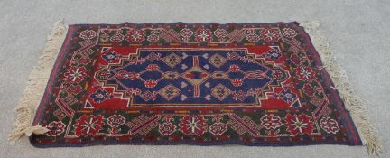 A hand made blue ground Belouch rug. L.147 W.86cm