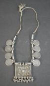 An antique silver Tribal Indian amulet necklace from Rajasthan, India adorned with eight silver 1