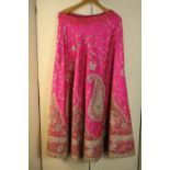 Two vintage Indian wedding skirts, one heavily embroidered and beaded pink silk Indian wedding skirt