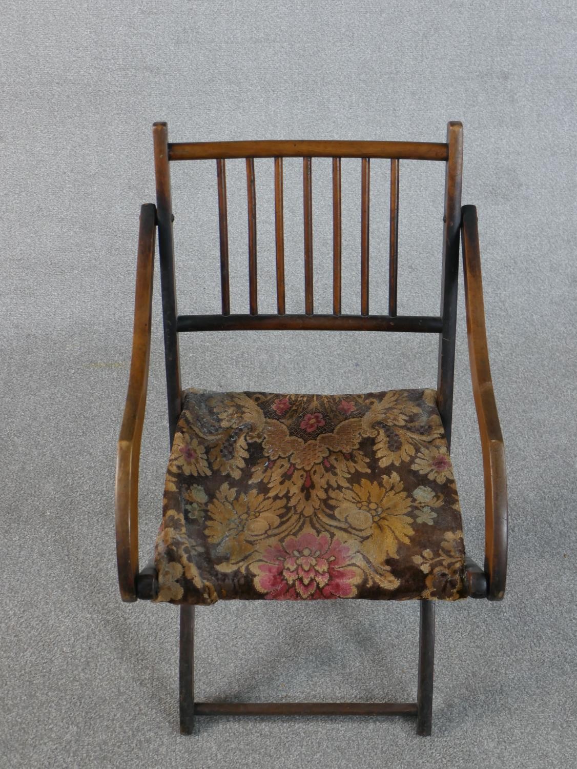 An early 20th century fruitwood folding armchair, with a spindle back, the seat upholstered in a - Image 3 of 6