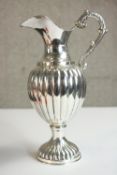 A gadrooned classical form handled sterling silver wine jug on circular base. Stamped 925. H.26 W.16