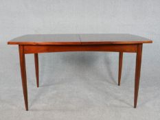 A circa 1960s White & Newton teak extending dining table, with a butterfly leaf, on tapering legs,