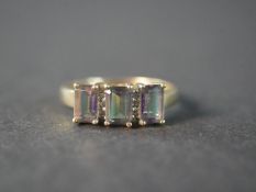 A 9 carat yellow gold mystic topaz and diamond three stone ring, set with three rectangular