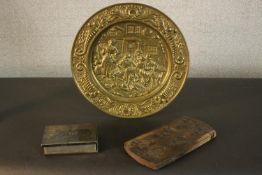 A repousse tavern scene brass plate, a silver plated travelling watercolour set and a Chinese