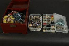 A lacquered box full of a large collection of crafting materials and accessories for jewellery