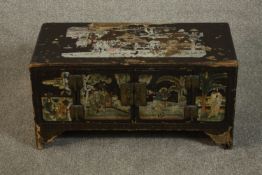 A Chinese lacquered chest, painted with various scenes to the top and front, with two cupboard doors