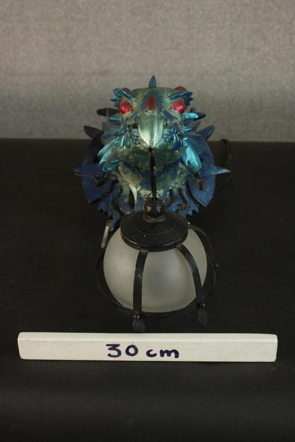 A moulded metallic painted dragon head wall lamp with caged frosted glass globe shade. H.33 W.23 D. - Image 2 of 7