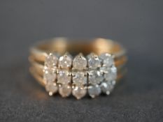 A 9 carat yellow gold and diamond dress ring set with fifteen round brilliant cut diamonds with a