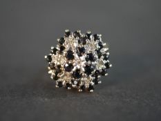 A sapphire and diamond 9 carat yellow and white gold cluster ring, set with seven round eight cut