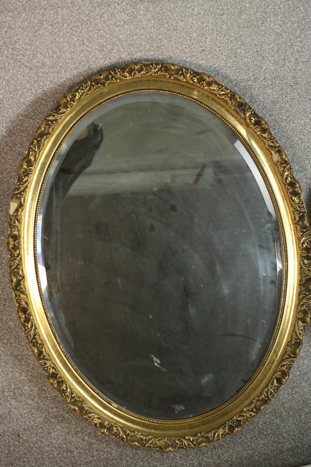 Two oval wall mirrors, one ebonized and one gilt framed. H.68 W.54cm. (largest) - Image 4 of 7