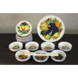 A Spanish hand painted ceramic eight person part dinner set decorated with fruit, signed verso.