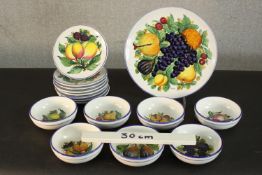 A Spanish hand painted ceramic eight person part dinner set decorated with fruit, signed verso.