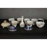 A collection of ceramics, including two blue and white willow pattern coffee cups and saucers, a