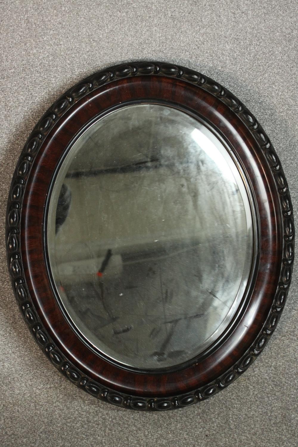 Two oval wall mirrors, one ebonized and one gilt framed. H.68 W.54cm. (largest) - Image 5 of 7