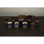 A collection of 19th century copper lustre items, comprising a teapot, jugs, cups, and a preserve