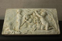 A relief plaster frieze depicting Classical putti. H.45 W.82 D.5cm.