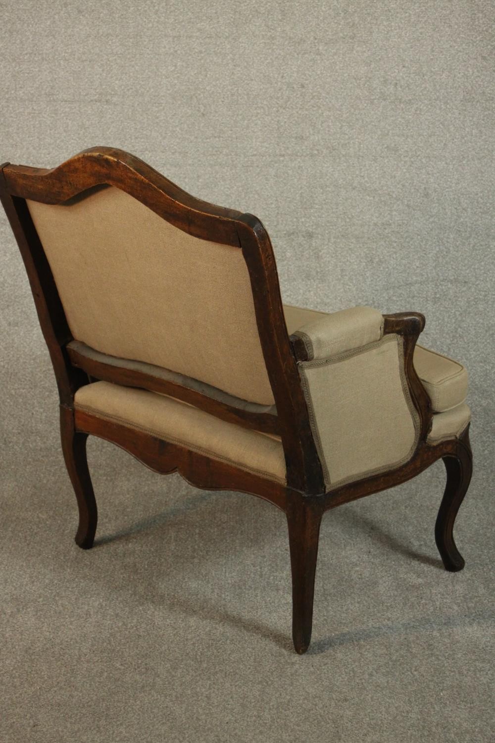 A French Louis XV provincial walnut fauteuil á la reine, with carved floral apron, cabriole legs, - Image 5 of 9
