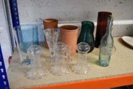 A collection of glassware, including three fluted edged light shades and a decanter.
