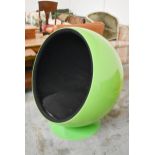 A vintage Eero Aarnio designed Ball Chair in a lacquered lime green finish on a swivel base.