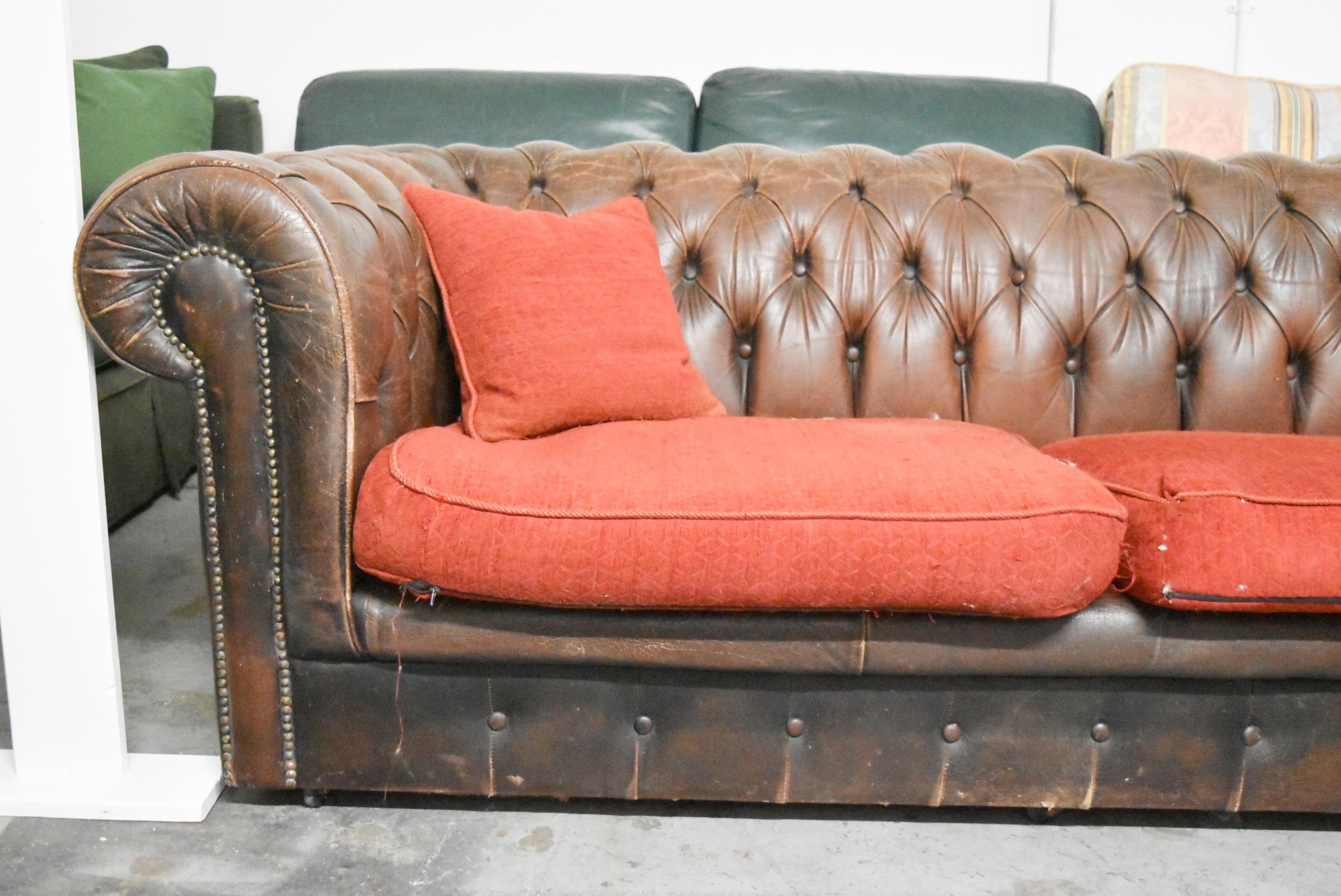 A Chesterfield two seater sofa in brown leather deep buttoned upholstery. H.70 x W.200 x D.82cm - Image 2 of 6