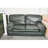 A Roche Bobois two seater sofa in deep green leather upholstery. W.150 x H.75 x D.90cm