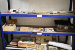 A shelf (Middle) of miscellaneous items including Cutlery, Vintage Booklets and Ephemera.