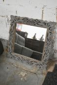 An Eastern hardwood mirror in foliate fret carved frame. H.79 x W.79 x D.4cm