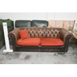 A Chesterfield two seater sofa in brown leather deep buttoned upholstery. H.70 x W.200 x D.82cm