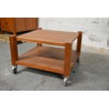 A contemporary hardwood low table on casters. H.48 x W.72 x D.72cm