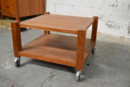 A contemporary hardwood low table on casters. H.48 x W.72 x D.72cm