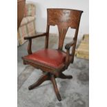 A late 19th century oak framed desk armchair with tilt and swivel action on a cabriole base. H.97