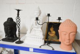A shelf of modern home decorative items, Buddhas etc.