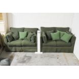 A pair of two seater sofas in green upholstery. H.73 x W.150 x D.85cm
