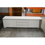 A contemporary low sideboard in a lacquered finish. L.180 x D.40 x H.49cm