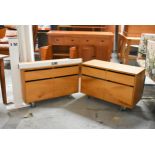 A pair of retro styled filing cabinets with drawers and doors on industrial style casters fitted