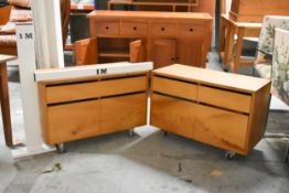 A pair of retro styled filing cabinets with drawers and doors on industrial style casters fitted