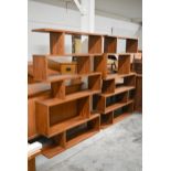 A pair of retro styled teak floor standing open wall shelves of asymmetric form. H.180 x W.120 x D.