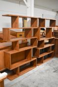 A pair of retro styled teak floor standing open wall shelves of asymmetric form. H.180 x W.120 x D.