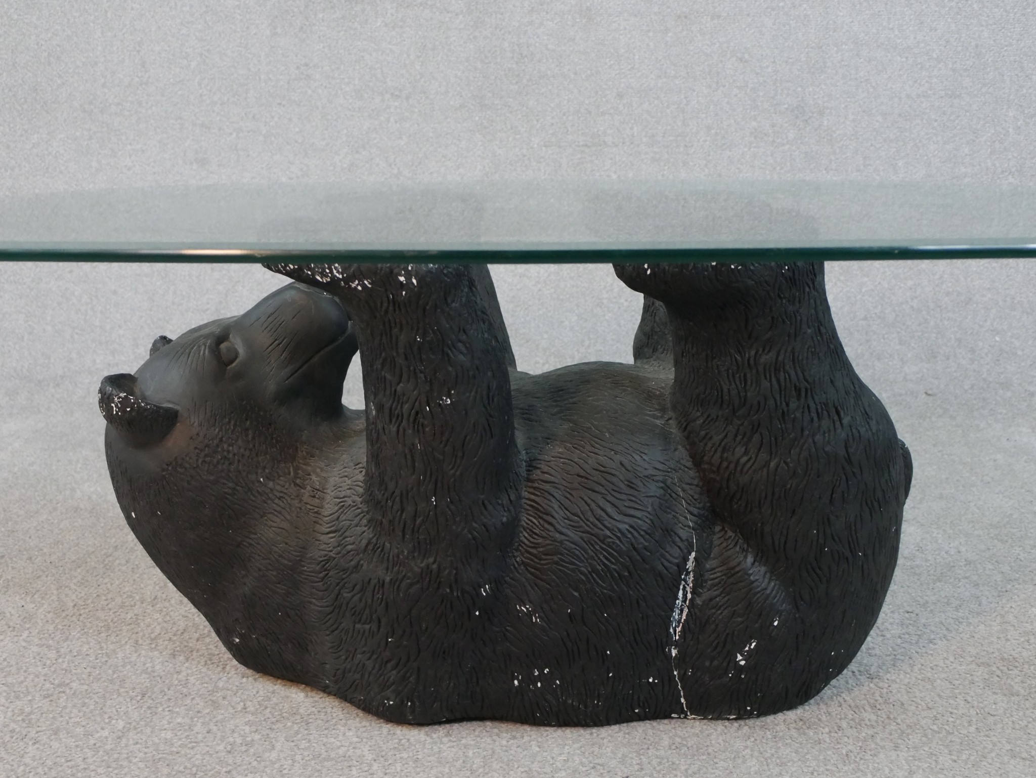 A contemporary glass topped coffee table supported by a moulded and painted bear. H.41 W.105 D. - Image 2 of 4