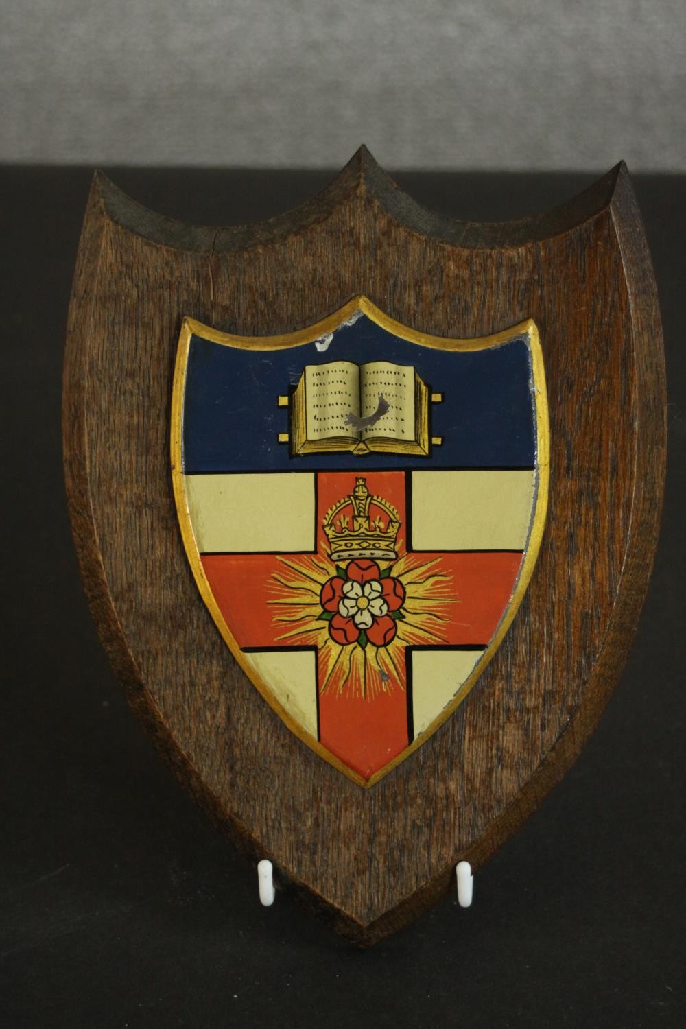 An early 20th century oak heraldic shield with hand painted metal panel to centre with open book and - Image 4 of 7