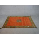A rust ground hand made Persian Gabbeh rug. L.180 W.122cm