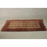 A beige ground hand made Belouch rug. L.180 W.102cm.