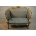 A Louis XV style giltwood canape sofa, with carved cresting and upholstered in blue fabric, with
