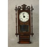 A circa 1900 rosewood and inlaid wall clock, the case with a carved and scrolling crest, the