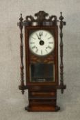 A circa 1900 rosewood and inlaid wall clock, the case with a carved and scrolling crest, the