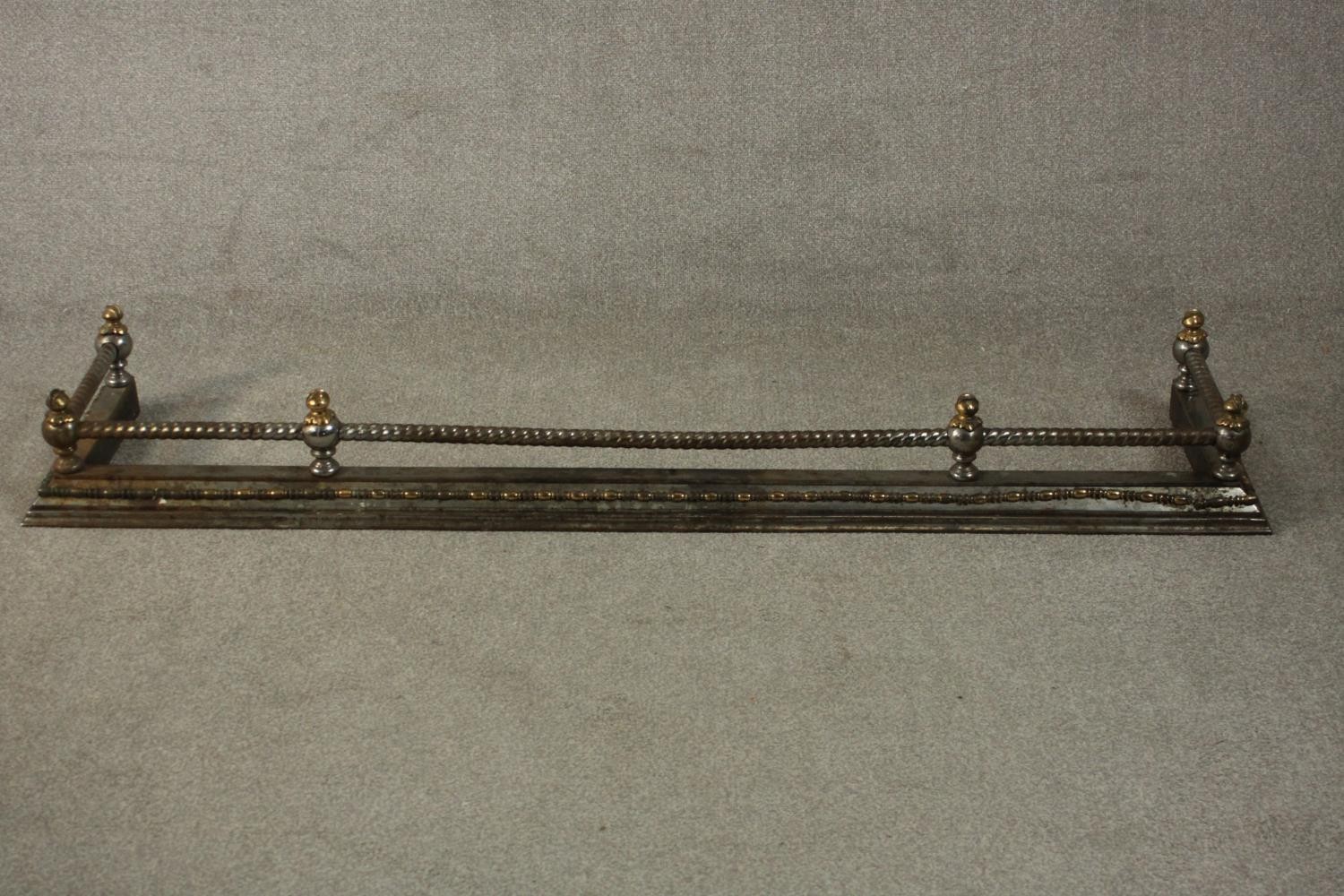 A 19th century steel and brass fender, with rope twist rail. L.170 D.40cm.