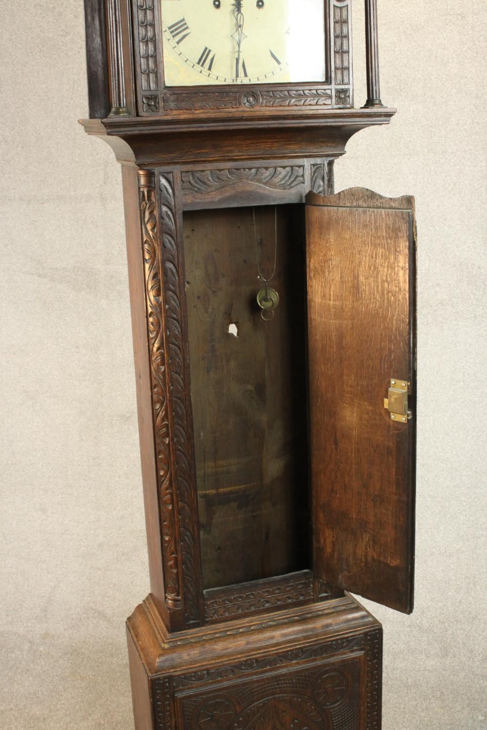 A 19th century carved oak longcase clock, the hood with a swan neck pediment and reeded columns, the - Image 3 of 13