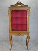 A French Louis XV style kingwood vitrine, with cast gilt metal furniture mounts, the glazed cupboard