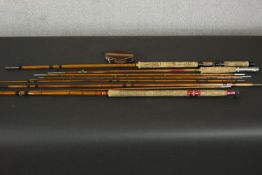 A collection of 19th century fishing rods and a mahogany and brass fishing reel. L.131cm. (largest)